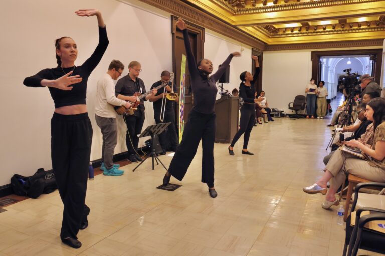 Dancers and musicians from Putty Dance Project perform in a hallway on the fifth floor of City Hall