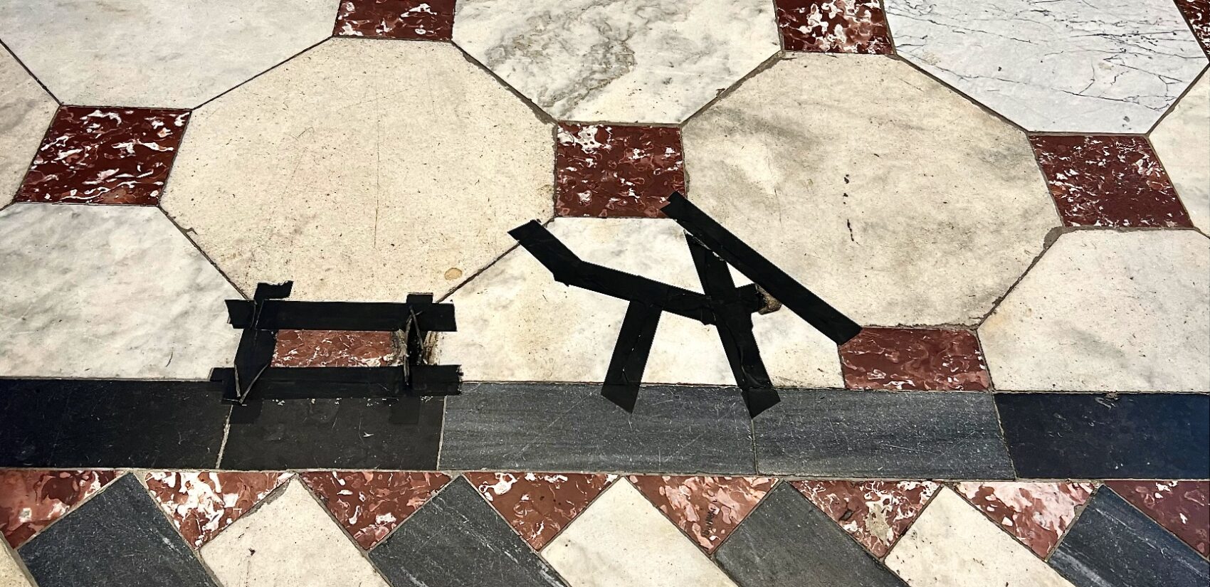 black tape on the marble floor