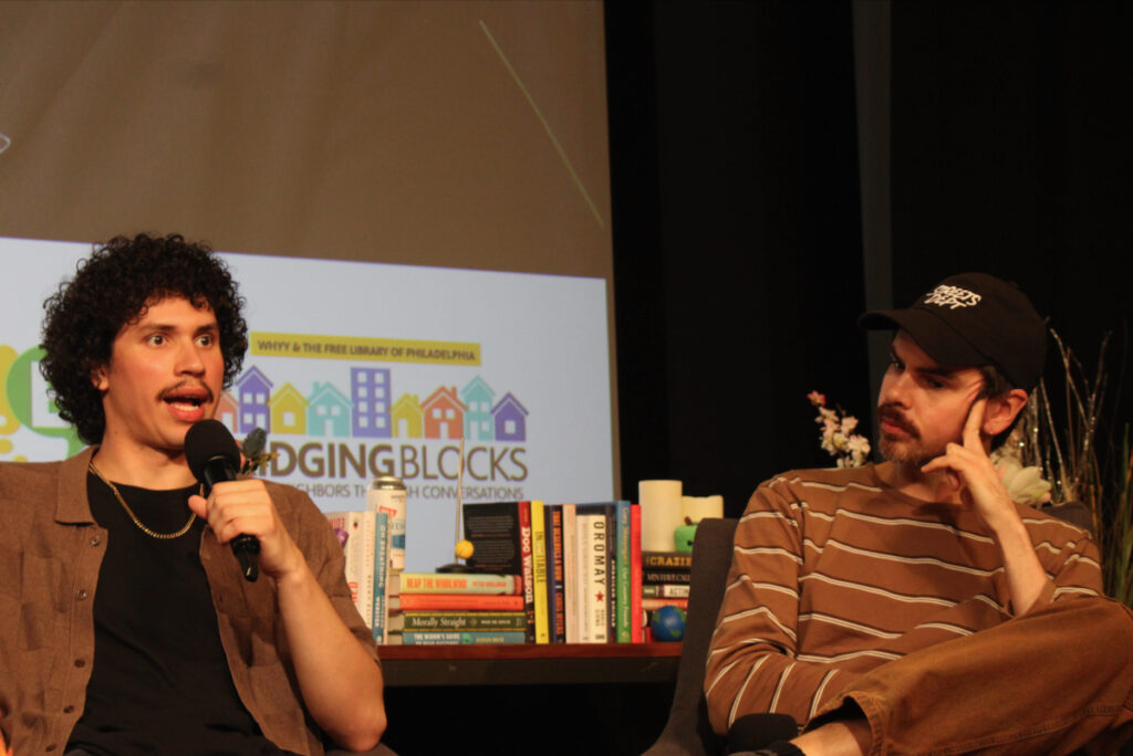 From left, Santiago Ortiz, content creator at No Shorts Media, and Conrad Benner, founder of Streets Dept., speak into microphones at the WHYY Civic News Summit