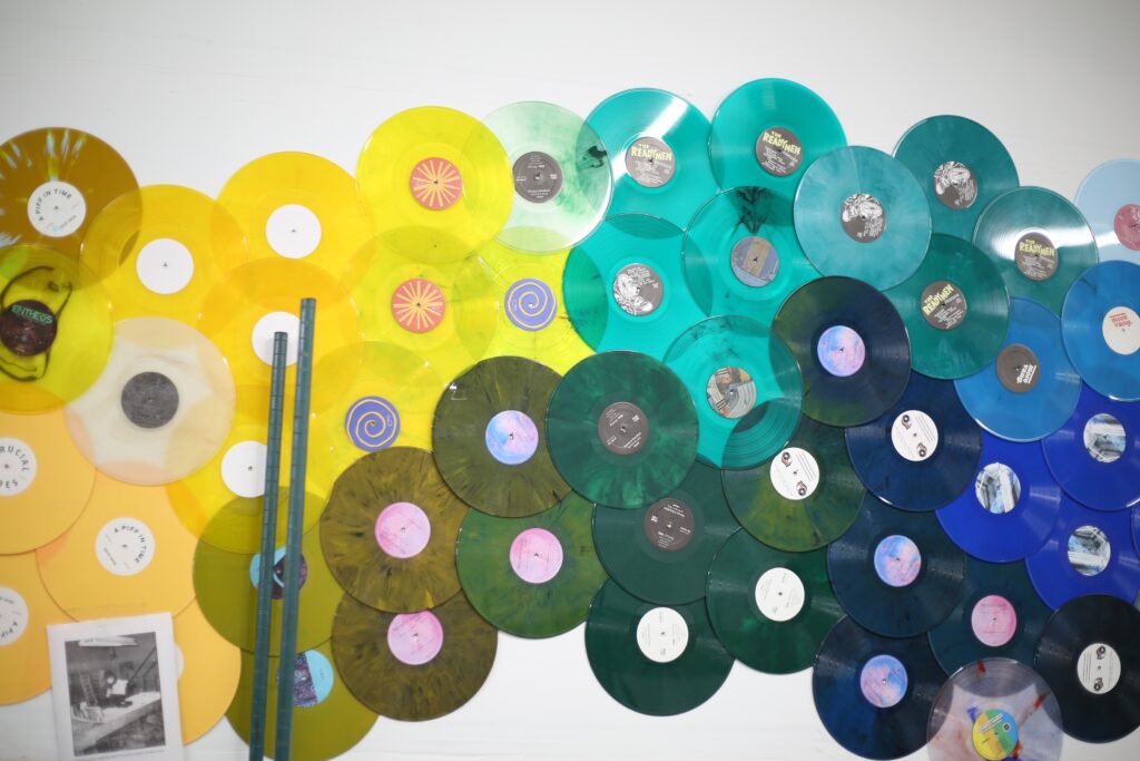 Hellbender-Vinyl-Philadelphia-10 yellow, green and blue records on a wall