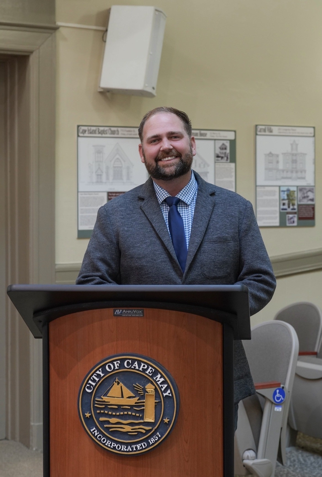 Zack Mullock, Democratic candidate for Congress, stands at a podium.