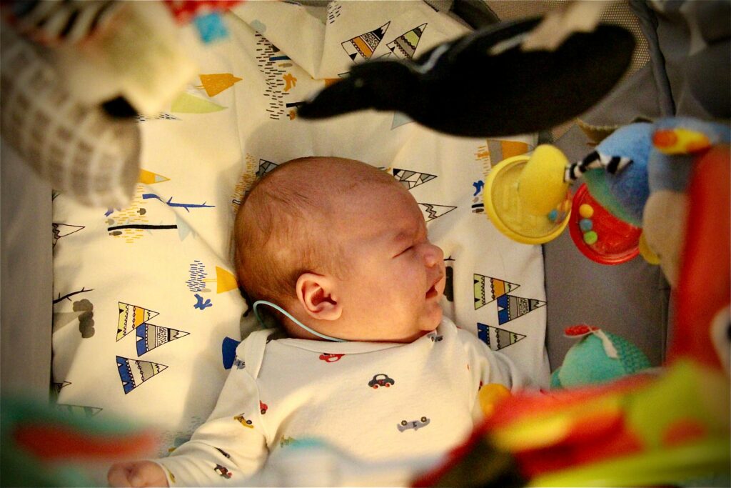 An overhead view of a baby in a crib
