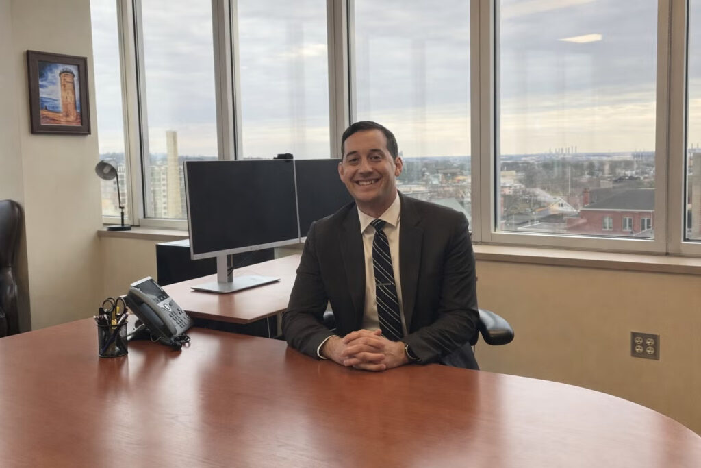 Benjamin Wallace posing for a photo in his office