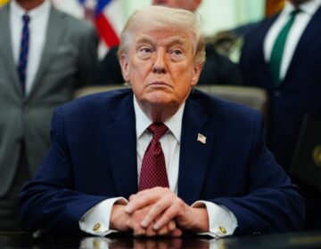 Donald Trump looks on