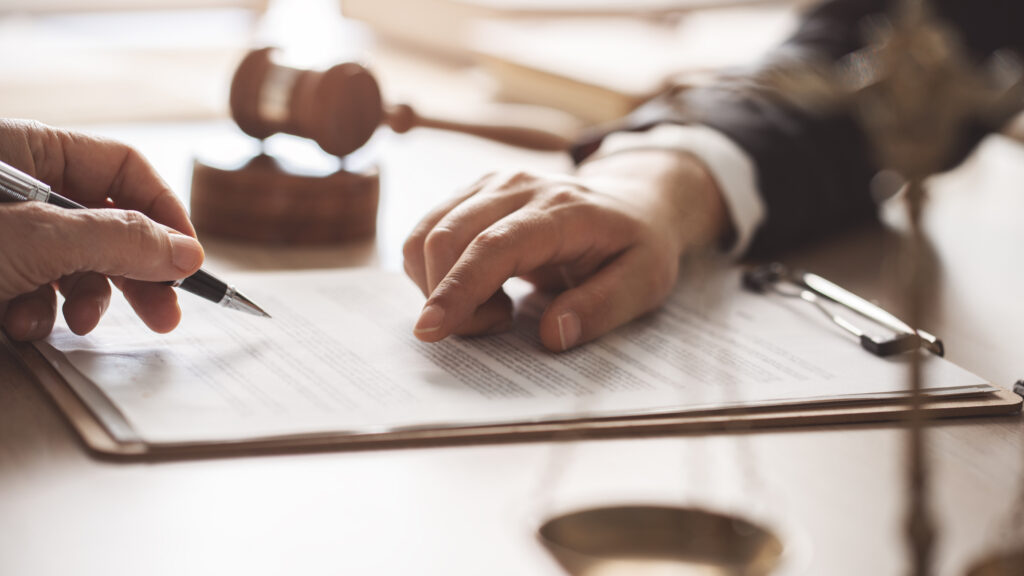 Concept of justice, law and legal system Hands point to a piece of paper