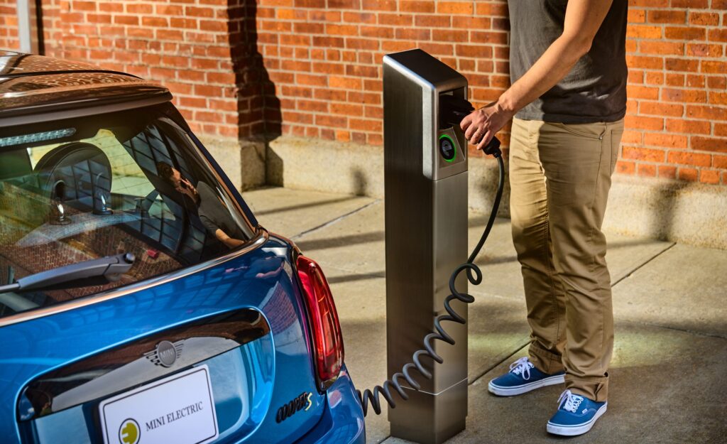A person is charging an electric vehicle