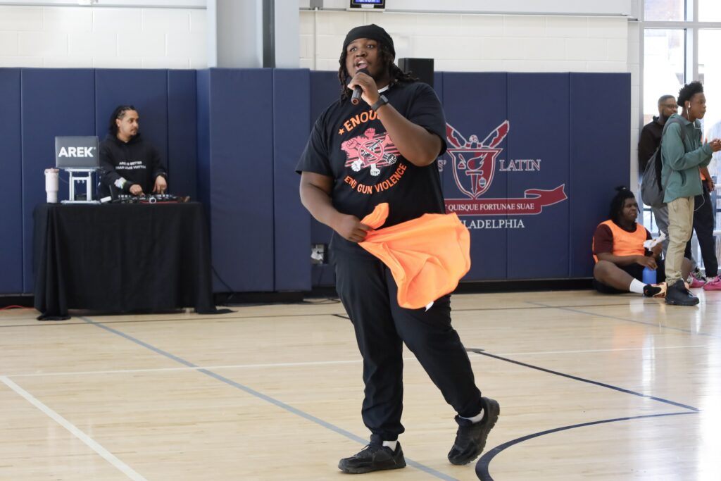 Kai Sample addresses the crowd from the court using a microphone