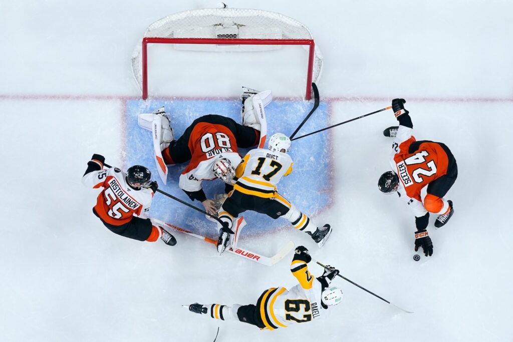 Penguins Flyers Hockey Pittsburgh Penguins' Bryan Rust (17) collides with Philadelphia Flyers' Dan Vladar (80) during the third period of Game 3 in the first round of the NHL Stanley Cup hockey playoffs Wednesday, April 22, 2026, in Philadelphia.