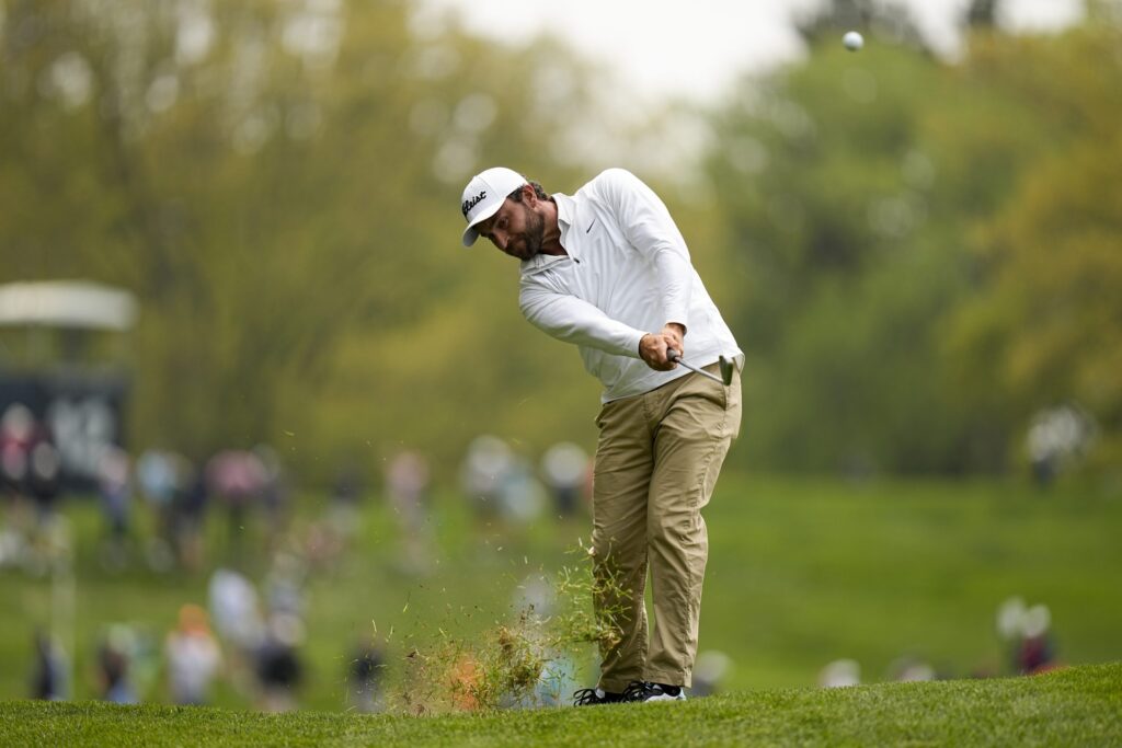 Braden Shattuck hitting a golf ball on the course