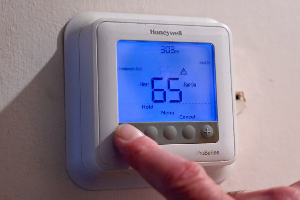 thermostat-npr-2025-11-06 copy A person adjusts their thermostat