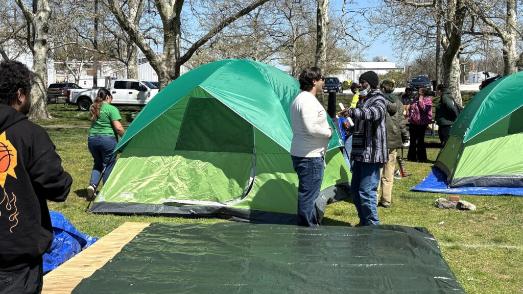 wilmington-encampment-sm-040926 Javier Horstmann, an official with Wilmington Mayor John Carney's office, speaks with an unhoused resident