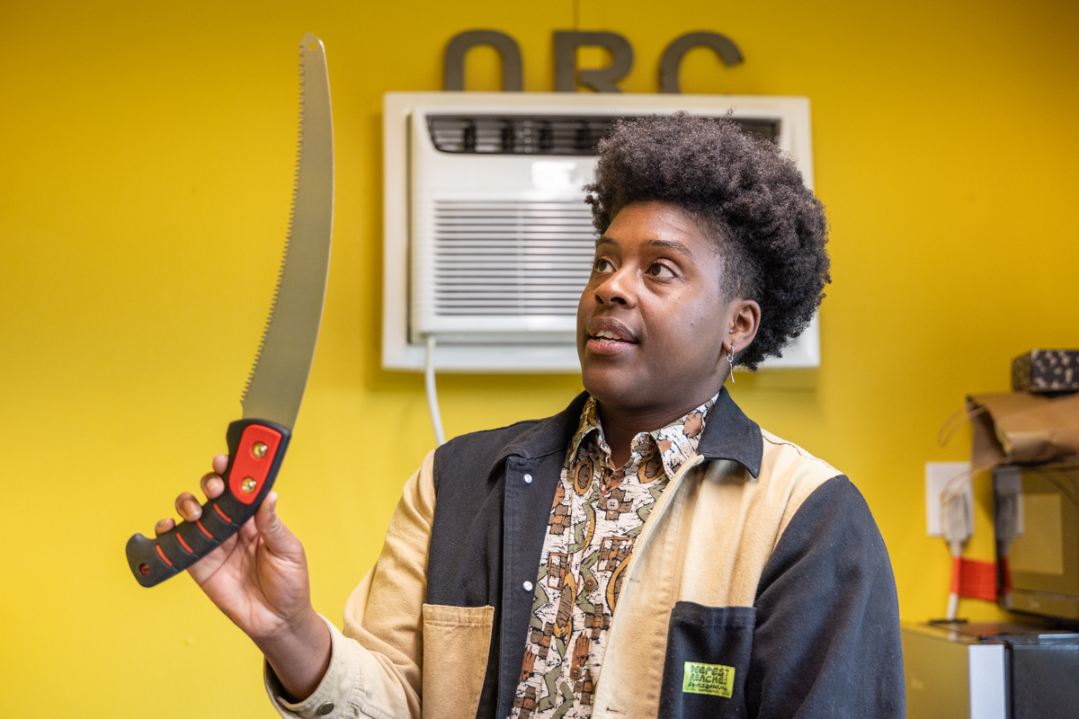 Ash Richards showing tools available at the Agricultural Resource Center in Fairmount Park