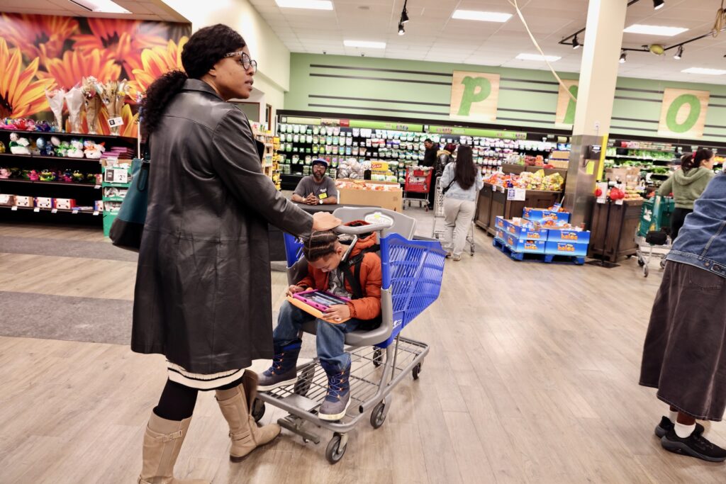 Constance Jones uses a Caroline's Cart to shop with her son at ShopRite