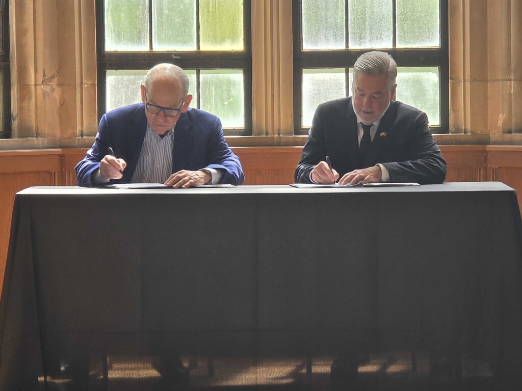 Joe-Neubauer-and-Temple-University-President-John-Fry Joe Neubauer and Temple University President John Fry sign a scholarship agreement helping children of Philadelphia's first responders pay for college
