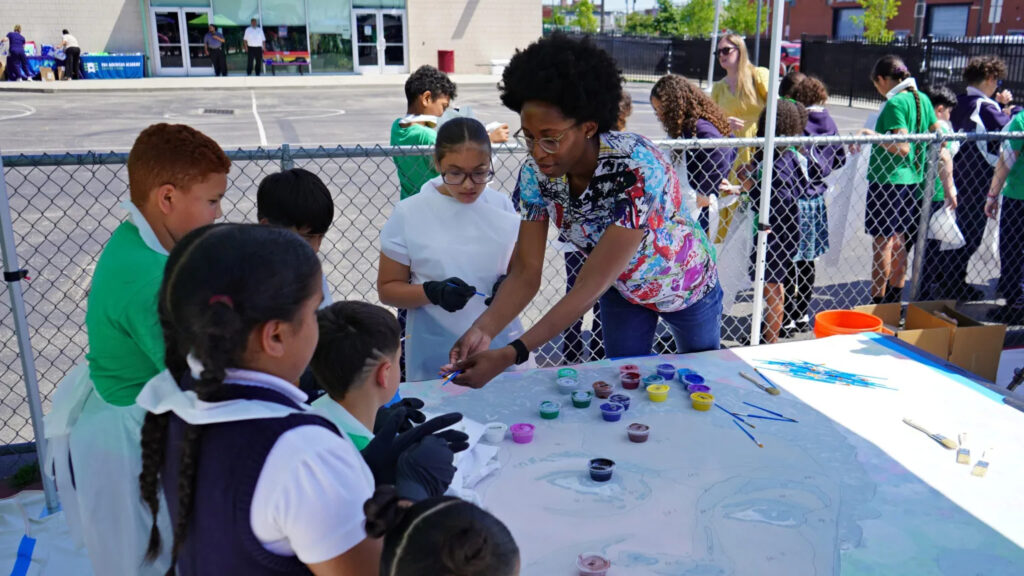 Pan American Academy Charter School mural Nilé Livingston helps students at Pan American Academy Charter School in Kensington paint a mural