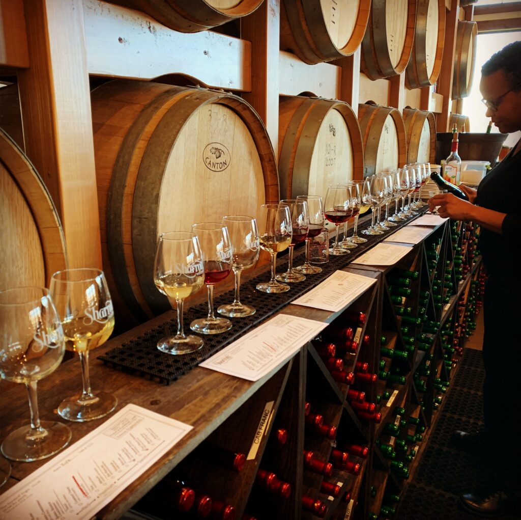 Tapping barrels of wine at the winery.
