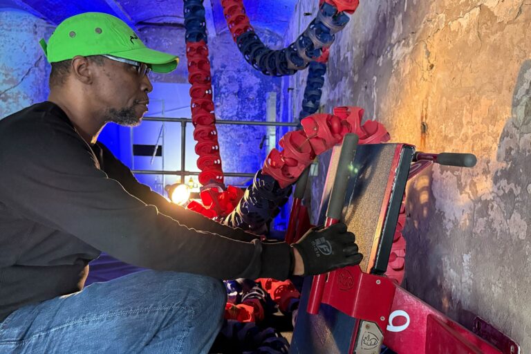 Artist Taji Ra’oof Nahl works on his installation