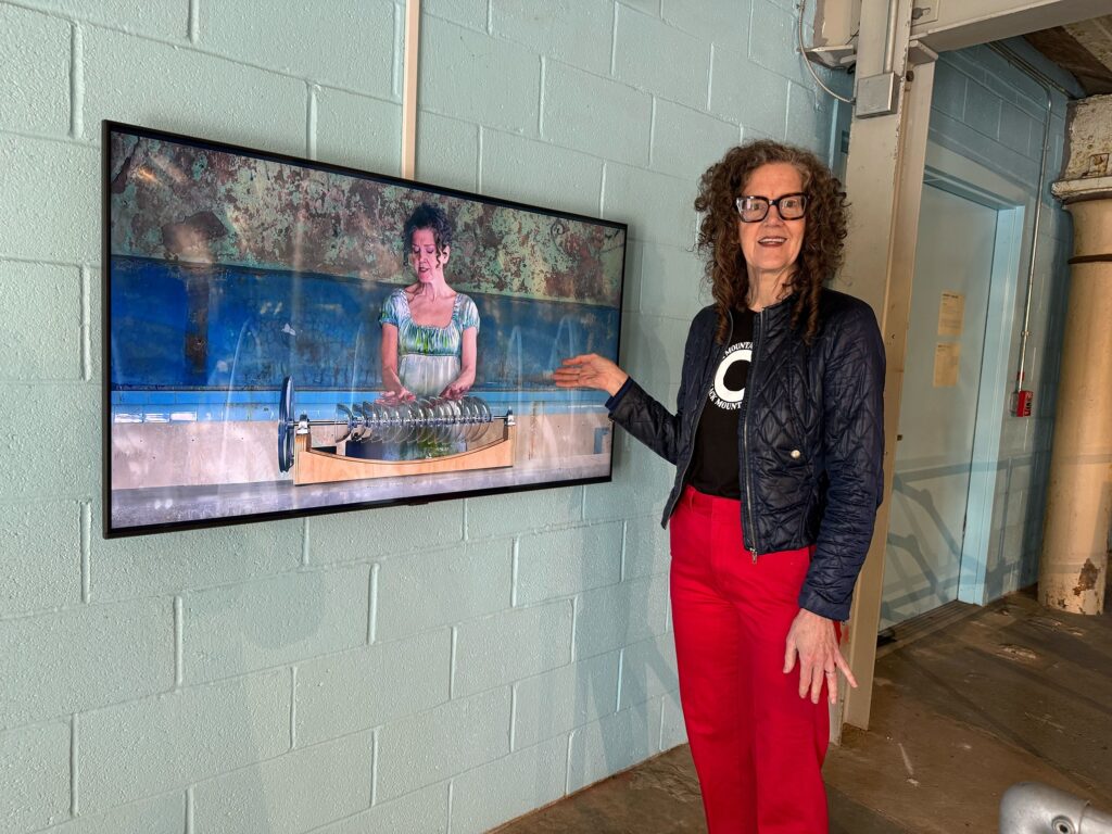 currents-exhibit-fairmount-water-works-2026-3 Martha McDonald watches herself on screen playing the armonica