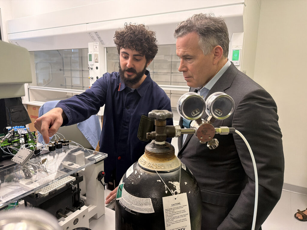 A bioengineering graduate student working at Penn's AIRFoundry, explains some of the lab's cutting edge medical research using artificial intelligence to Senator David McCormick.