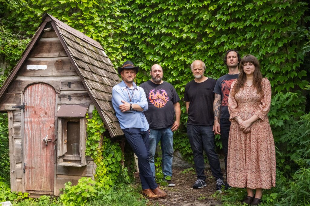 The five members of Henbane pose during an outdoor photo shoot.
