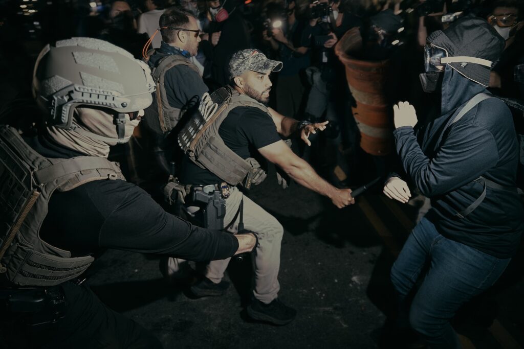 ICE agents use their baton as they clash with protesters outside the Delaney Hall detention center during a protest on Wednesday, May 27, 2026, in Newark, N.J.
