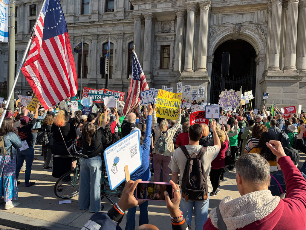 Unions and labor activists rally at City Hall to commemorate Mayday