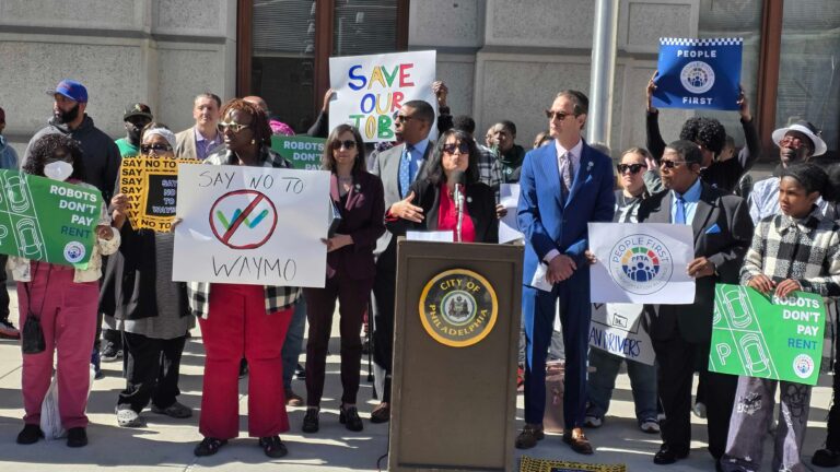 Anti-Waymo protestors gathered outside City Hall