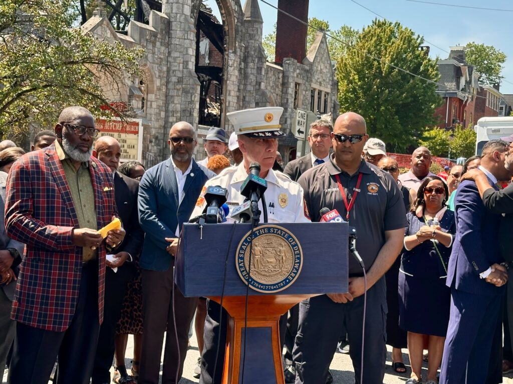John Looney speaking at a podium.
