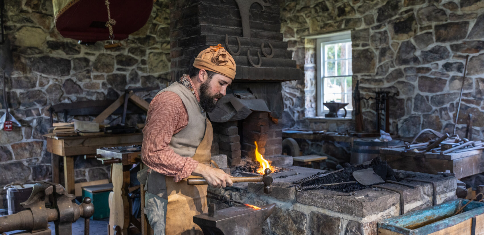 Ross Heutmaker giving a blacksmithing demonstration