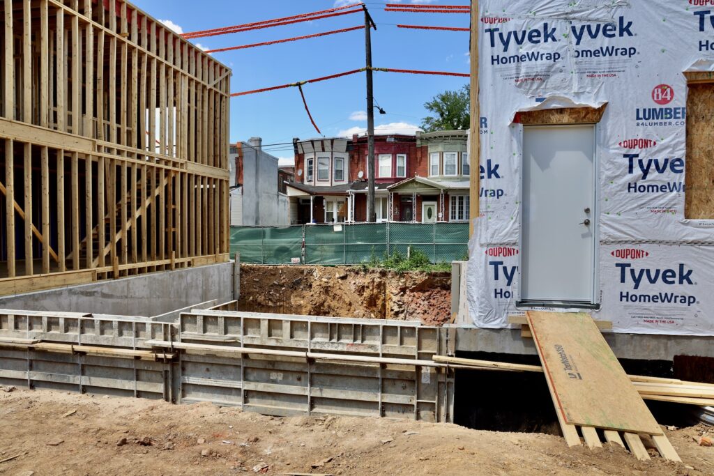 2026 06 01-e lee-philadelphia venango street-turn the key housing development groundbreaking foundation A house is being built at a construction site.