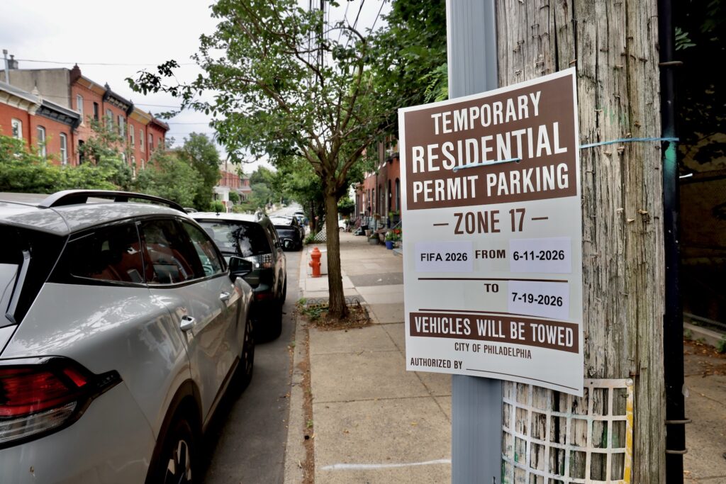 A sign on a lamppost warns drivers that the street is for residential permit parking only.