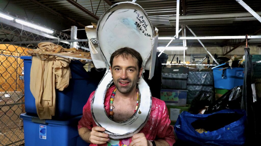 Rose Jarboe of the Bearded Ladies Cabaret tries on the cardboard toilet