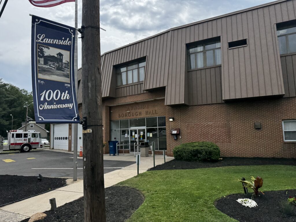 A banner outside of borough hall marks the 100th anniversary