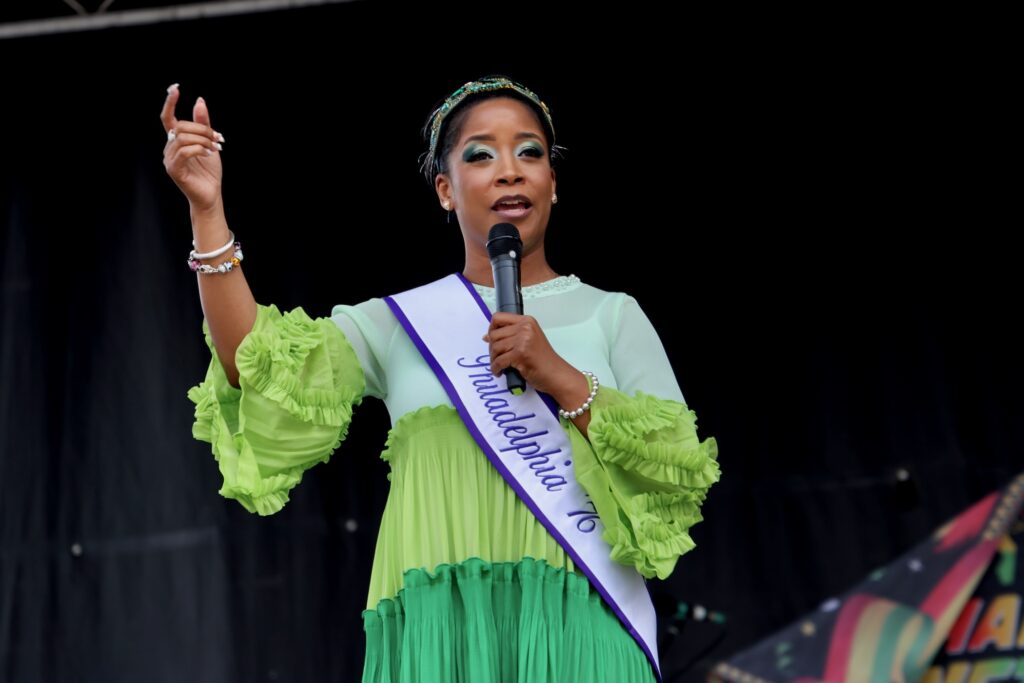Ashley Jordan speaking into a microphone on stage.