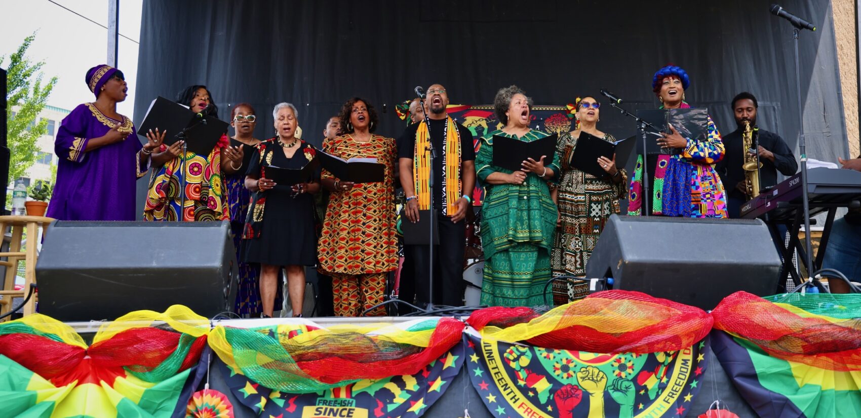Members of a chorus singing on stage.