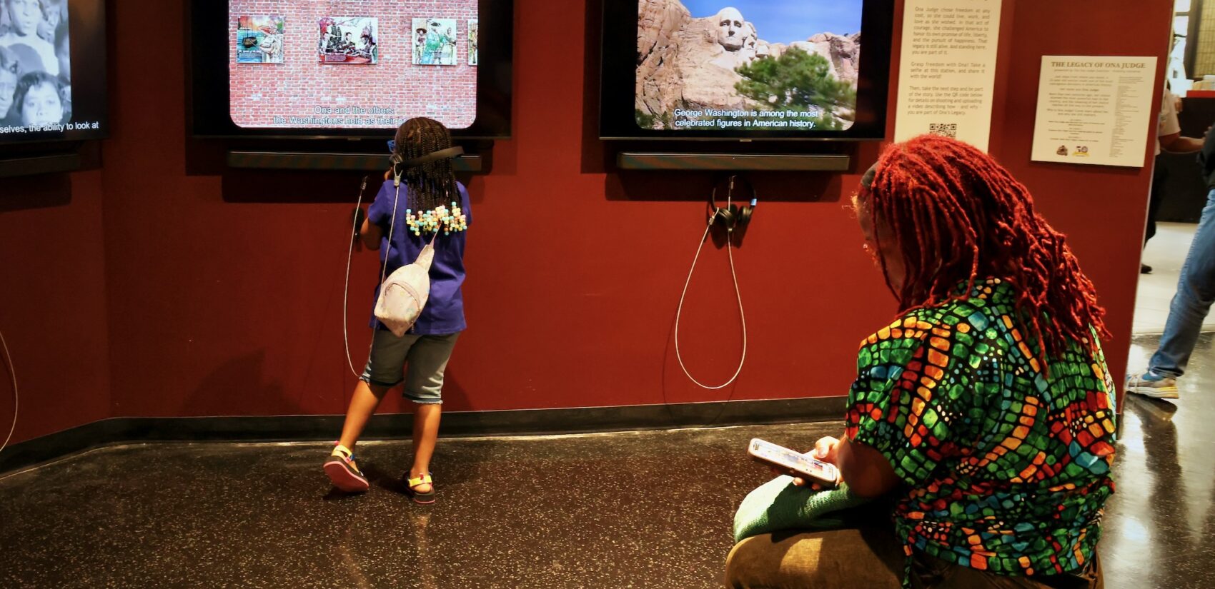 People looking at the exhibit in the museum.