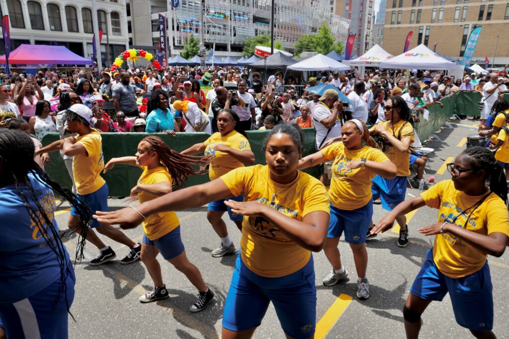 2026 06 19-e lee-philadelphia african american museum-juneteenth block party west powelton steppers Performers dancing in the street during the celebration.