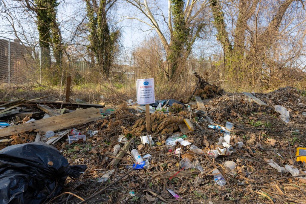 A vacant lot filled with trash.