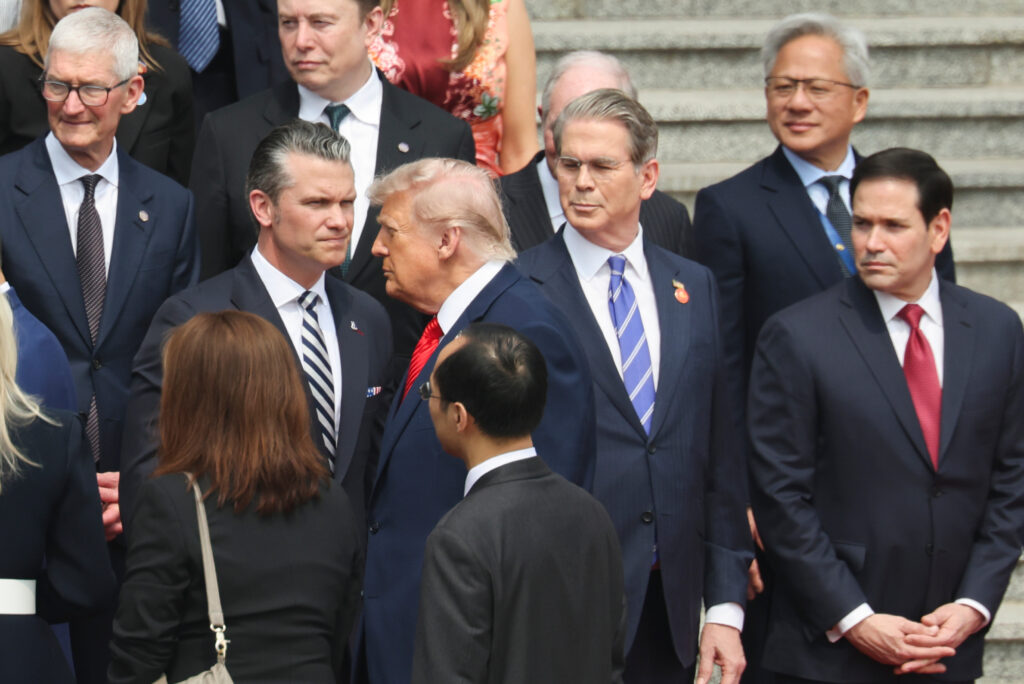 China Trump U.S. President Donald Trump looks on next to, from bottom right, U.S. Secretary of State Marco Rubio, U.S. Treasury Secretary Scott Bessent, U.S. Defense Secretary Pete Hegseth, Nvidia CEO Jensen Huang, top right, Tesla CEO Elon Musk, Apple CEO Tim Cook, top left, and others during a welcome ceremony at the Great Hall of the People in Beijing, Thursday, May 14, 2026. (Maxim Shemetov/Pool Photo via AP)