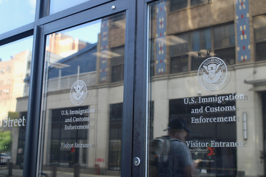 Philadelphia-ICE-Field-Office A glass door with the U.S. Immigration and Customs Enforcement logo and title on it in Philadelphia