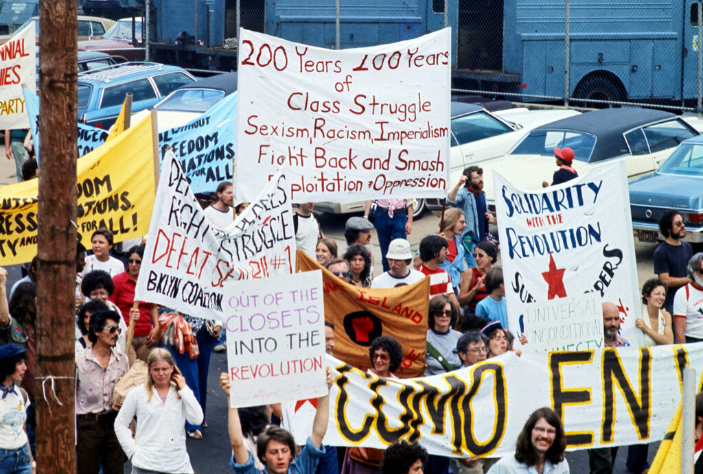 Sin-Colonias-200-class-struggle-1976-march A group of people hold various signs about class struggles during a protest in 1976.