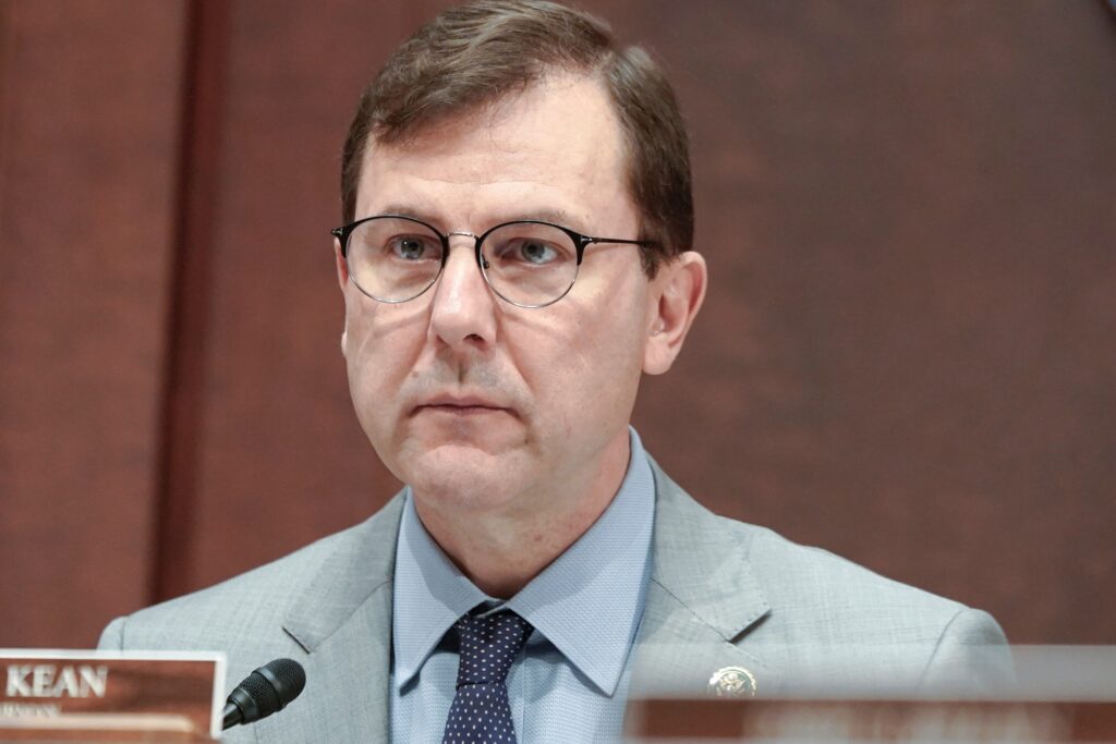 Tom Kean sitting behind the table during a congressional hearing.