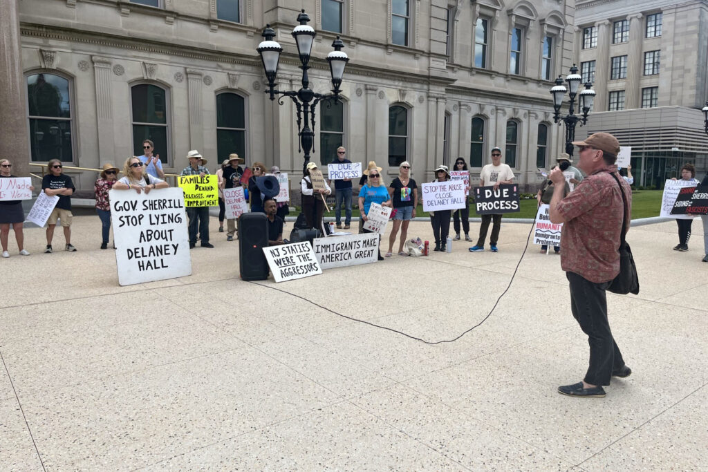 Protesters holding up signs at the Capitol.