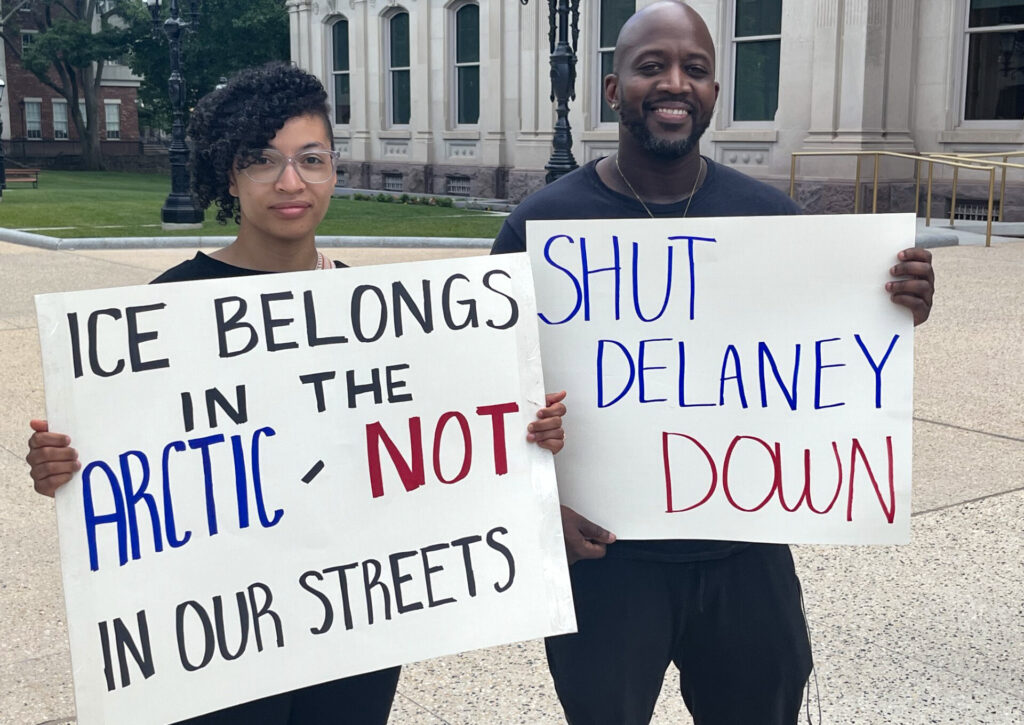Protesters holding up signs at the Capitol.