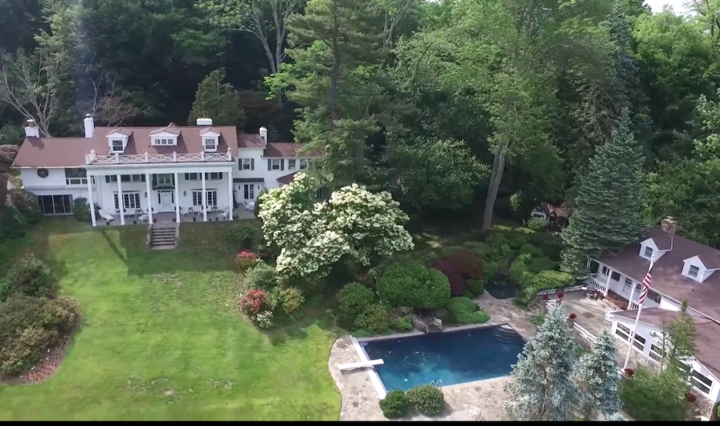 An aerial view of a large estate with a swimming pool.
