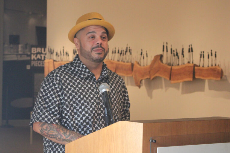 Roberto Lugo posing for a photo in the museum.