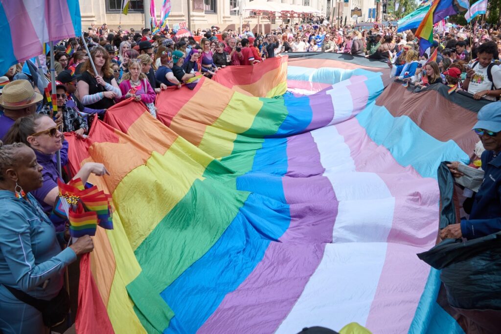pride-flag-bp-2026-06-03 Many people holding up a massive Pride flag