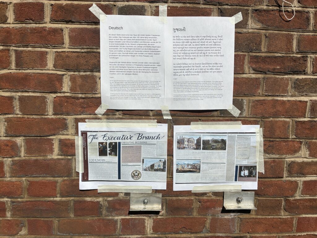 Printed photos of the removed exhibits are taped