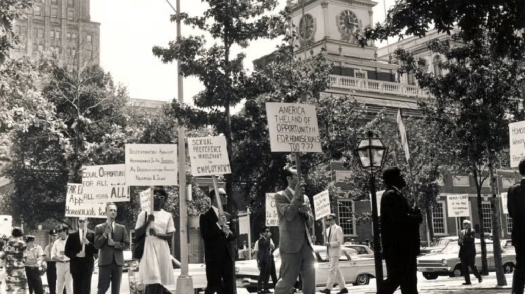 protesters-7-4-65-temple-urban-archives Protesters marching in front of the building holding up signs.