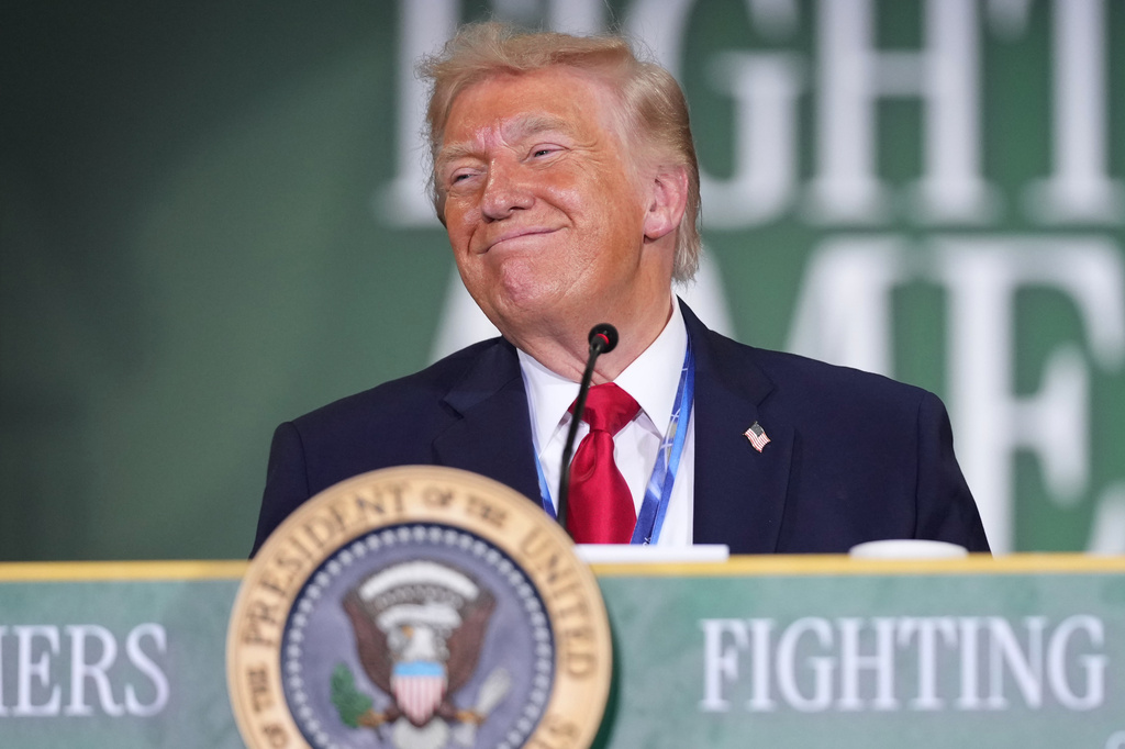 President Donald Trump stands behind a podium